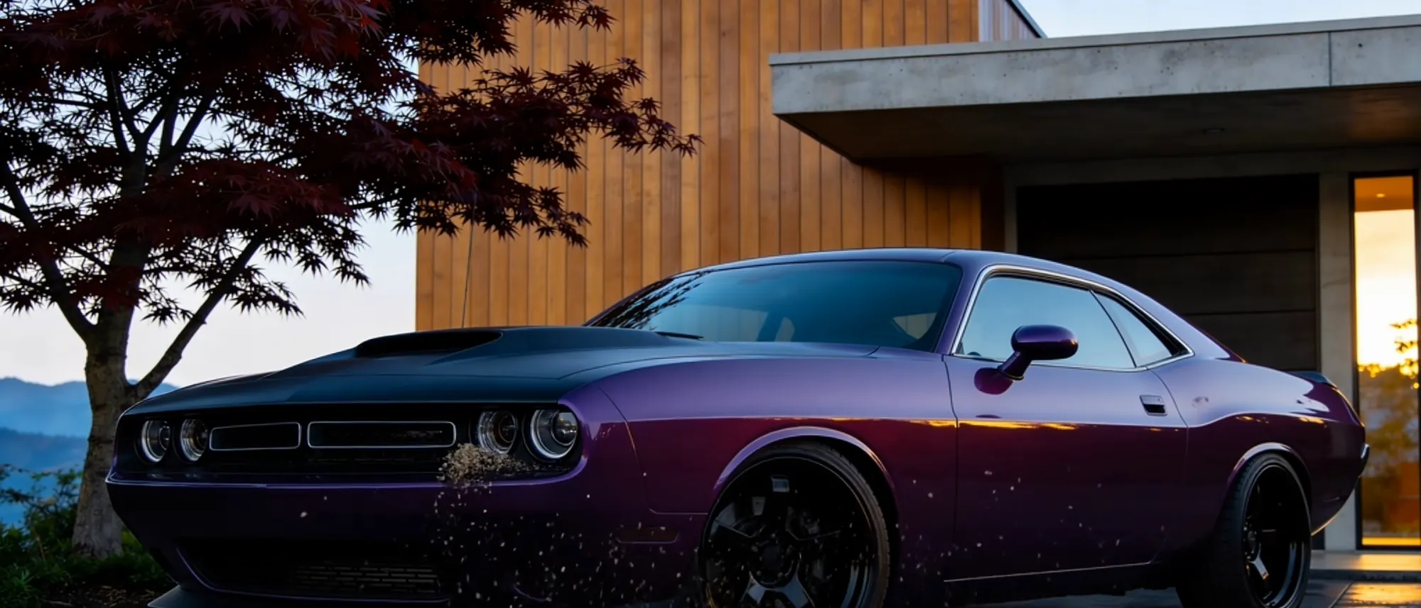 A dark coupe at dusk with water still standing on the coated paint