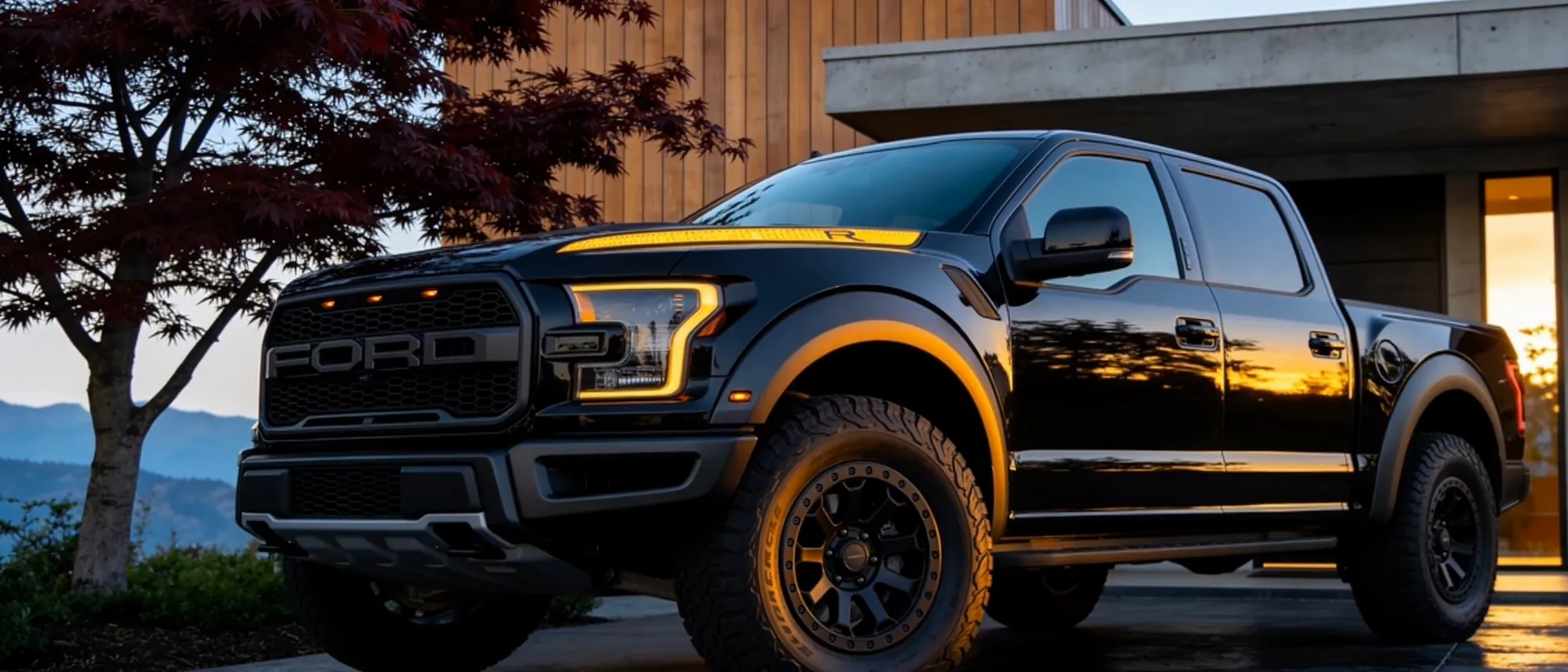 A black pickup standing at dusk, the coated paint holding the last of the light